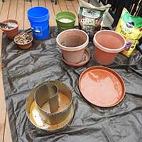 an herb spiral and the tools and materials needed for planting it